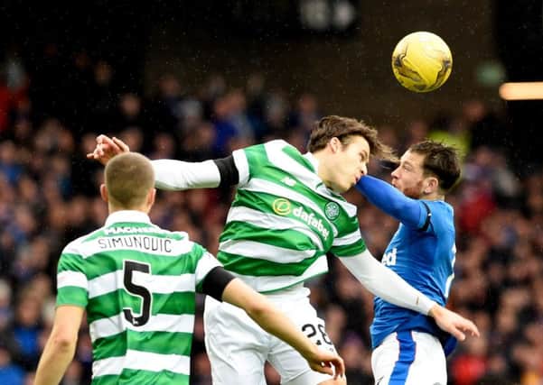 Celtic's Erik Sviatchenko (left) and Rangers' Joe Garner (right) battle for the ball . Photo : Ian Rutherford/PA Wire.