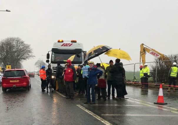 Activists stage a 'slow walk' protest in front of a lorry at the fracking site at Preston new Road, Little Plumpton, where work has begun to prepare the site for shale gas drilling.