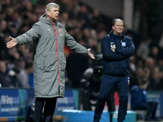 Managers Arsene Wenger and Simon Grayson look on at Deepdale.