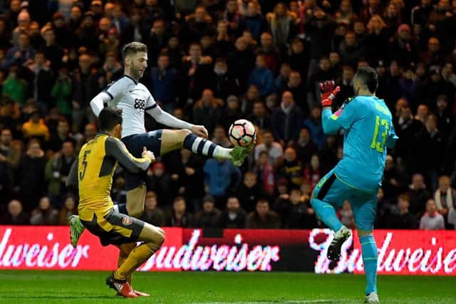 Preston North End's Paul Gallagher (centre) lobs Arsenal goalkeeper David Ospina but the ball is cleared off the line
