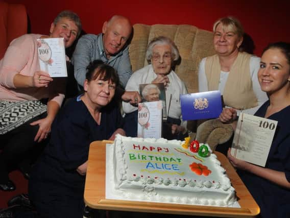 Alice Zealey celebrates her 100th birthday with family, friends and staff at Lostock Lodge care home, Preston, from left, Christine Harker, Ken Harker (Alice's nephew), Sharon Smithson (front left), centenarian Alice Zealey, care home manager Anita Mitchell and Rebecca Giddins.