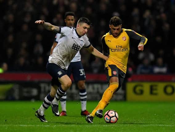 PNE striker Jordan Hugill takes on Arsenal's Alex Oxlade-Chamberlain