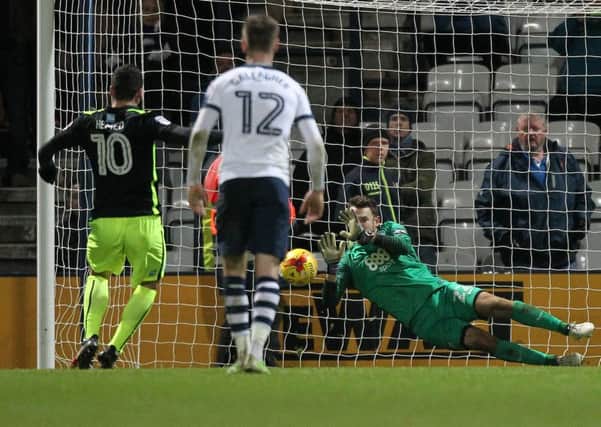 Preston goalkeeper Chris Maxwell dives to save Tomer Hemeds stoppage-time penalty