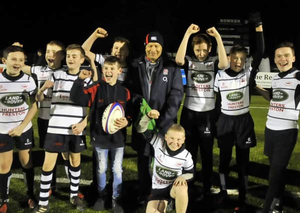 England coach Eddie Jones with some of the youngsters at Preston Grasshoppers on the opening of their pitch