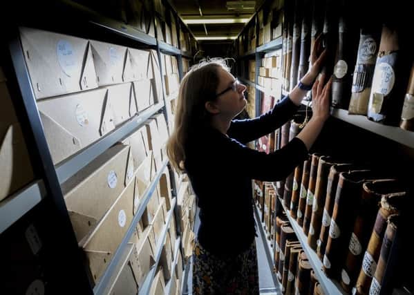 Archivist Keri Nicholson checks the  records