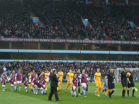 The teams make their way out at Villa Park.