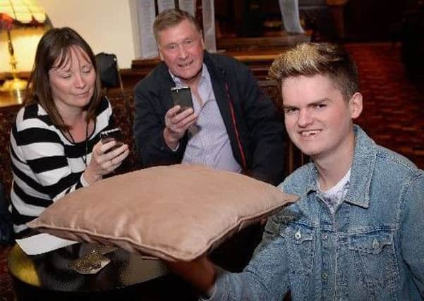 Thomas 'Bounce' Senior attempting a cushion spinning world record at the Boot and Shoe, Elswick, watvhed by timekeepers Alison Trippier and Mike Kirkham.