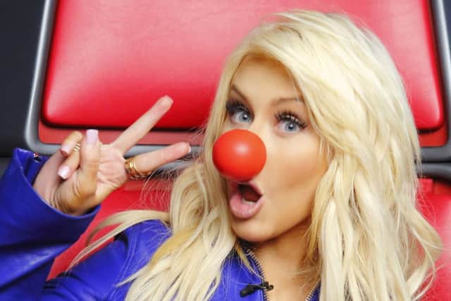 This undated photo provided by NBC shows Christina Aguilera posing for a photo for "Red Nose Day." Britain's famed Red Nose Day charity event will make its U.S. debut with a NBC special on Thursday, May 21, 2015 (8-11 p.m. ET), benefiting anti-poverty groups. NBC said Wednesday, March 18, 2015, that money raised by the three-hour Red Nose Day broadcast will be used to help children and their families in need worldwide. (AP Photo/NBC, Trae Patton)