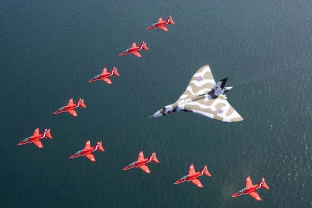 The Red Arrows flying with the last flying Vulcan bomber XH558