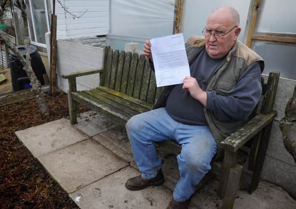 Allotment owner John Johnson-Moran faces possible eviction after it was discovered he had buried his pet dog Max on his Lawson Road plot. John on the bench positioned over Max's grave with his letter from the council asking him to exhume the remains.  PIC BY ROB LOCK 10-2-2017
