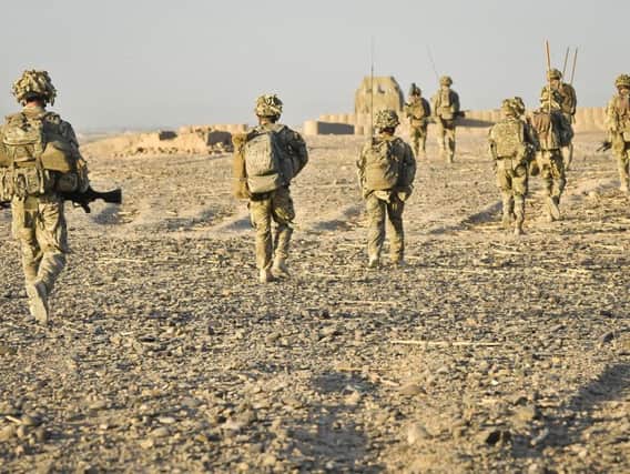 Soldiers return to their base after conducting a successful dawn foot patrol in the Nahr-e Saraj district, Helmand Province, Afghanistan