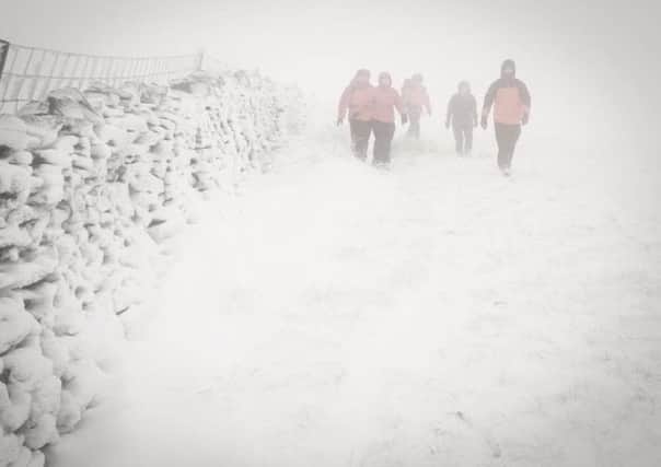 Photograph taken by team Doctor for Rossendale and Pendle Mountain Rescue John Ealing, walking the lost persons back to safety on Pendle Hill
