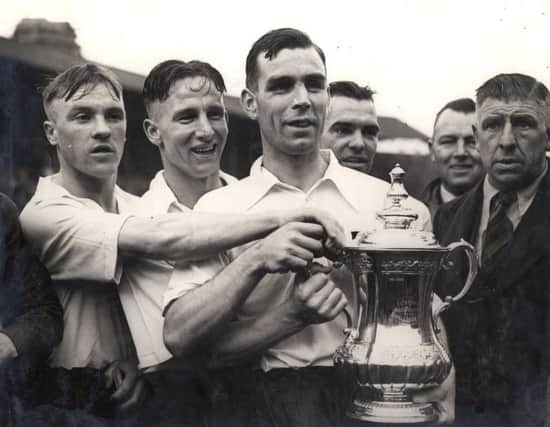 Bill Shankly, Andy Beattie, Tom Smith and Frank Gallimore proudly showing off the FA Cup in 1938
