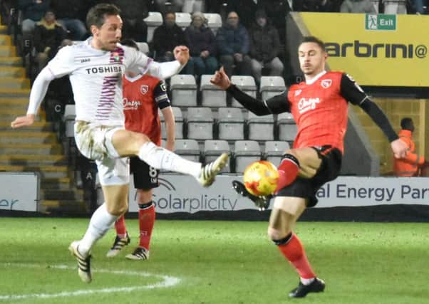 Michael Rose battles for the ball against Barnet.