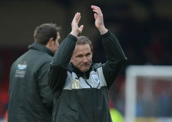 Preston North End's Manager Simon Greyson applauds the travelling PNE Fans
 at the end of his first game in charge at Swindon in 2013