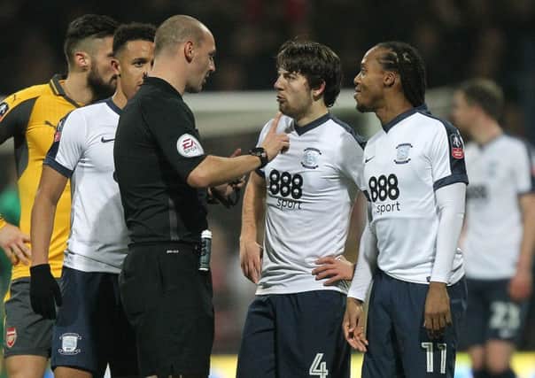 Referee Robert  Madley talks to Preston North End's Ben Pearson during the FA Cup game against Arsenal