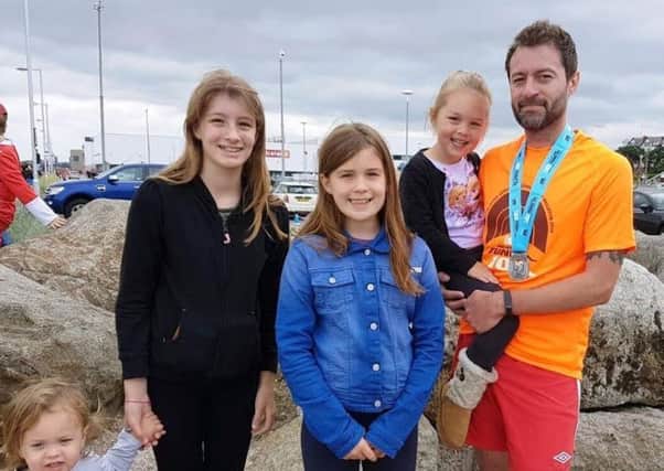 From left to right, Lorien, two, Abbey, 13, Megan, nine, and Matilda, five, with their dad David Stott