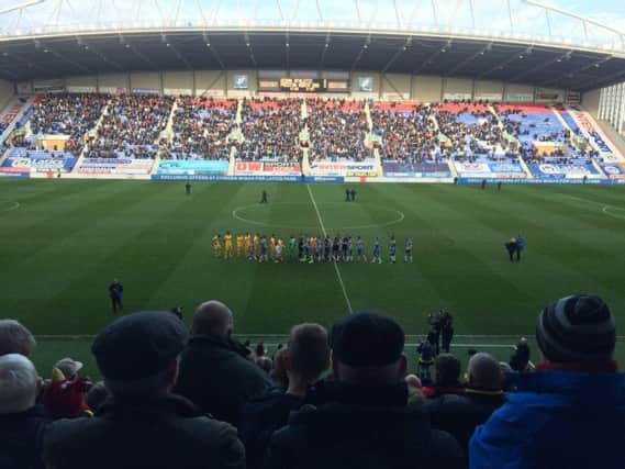 The sides take to the field at the DW Stadium.