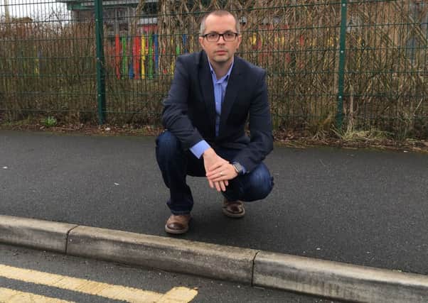 Euxton parish councillor Aidy Riggott pictured at the break in the double yellow lines in Village Way, Buckshaw