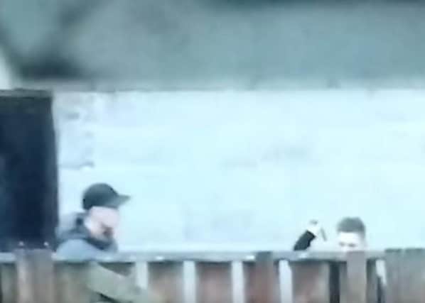 Still from a video showing young thugs throwing a knife into the garden of a family in Deepdale.