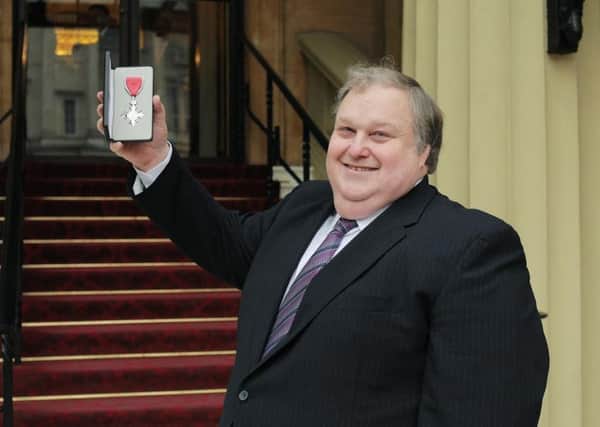 Simon Rigby with his MBE at the Palace