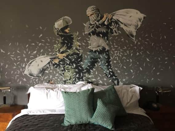 A bedroom in a new guesthouse shows artwork by Banksy in the West Bank city of Bethlehem