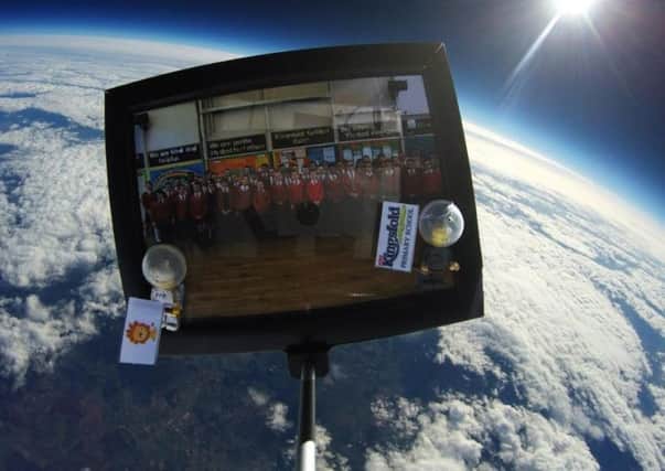 A picture of Kingsfold Primary School students as they float in space using a weather balloon.