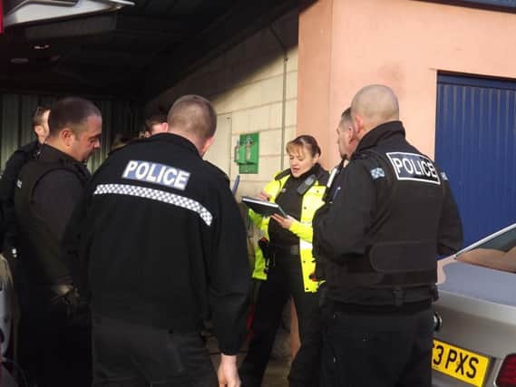 Officers go through a briefing before going out on patrol