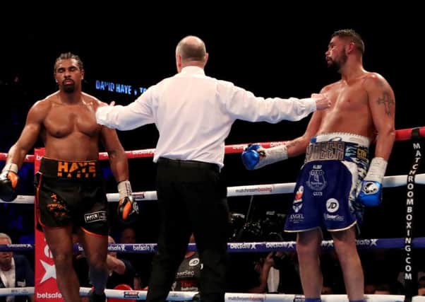 Phil Edwards splits David Haye, left, and Tony Bellew at the O2Arena