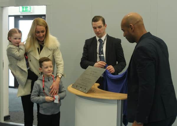Neil's widow Kim with their children Max and Daisy watch maths and PE teacher Gavin Clark and Trevor Sinclair (right) unveil the plaque at Central Lancaster High School.