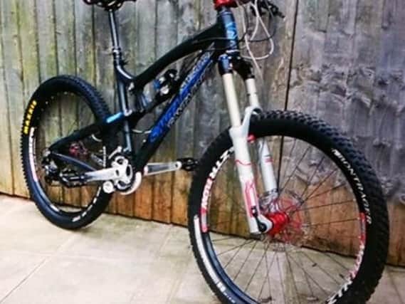 The thief stole a high-end Santa Cruz mountain bike along with other items while the occupier was out, say police.