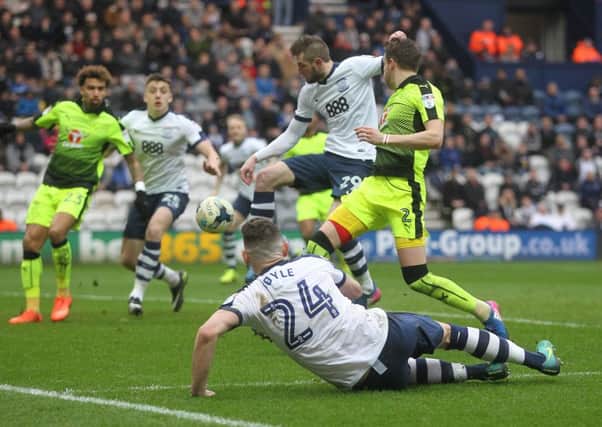 Andy Boyle watches from the floor as Tom Barhuizen scores PNE's third goal