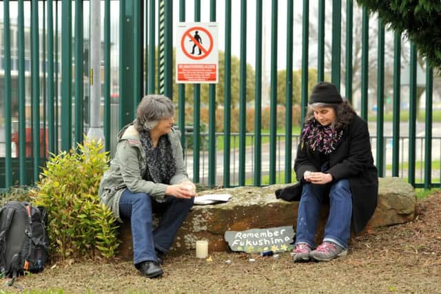 Photo Neil Cross
Marianne Birkby and Sam Morris staging an anti nuclear protest outside Springfields nuclear plant on the anniversary of the Fukushima nuclear disaster