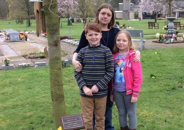 Lisa Douthwaite with son Matthew and daughter Lily beside their brother Jack's memorial plaque at Longridge Road Crematorium.