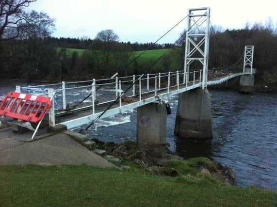 The damaged Dinckley Suspension Bridge near Hurst Green - closed after the Ribble  burst its banks on December 26 , 2016