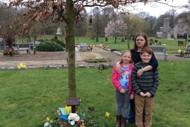 Lisa Douthwaite with son Matthew and daughter Lily beside their brother Jack's memorial plaque at Longridge Road Crematorium.