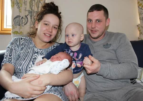 Lauren Doherty, 22, holding baby Charlie who was born at Derian House Children's Hospice on March 15. Also pictured is big sister Gracie, 18 months, and dad Zak Greenwood, 26.