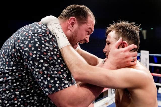 Tyson Fury consoles Isaac Lowe after the fight was waved off.