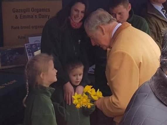 Prince Charles greets two young spectators
