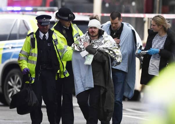 Owen Lambert from Morecambe is treated by emergency services near Westminster Bridge.  (Photo by Carl Court/Getty Images)