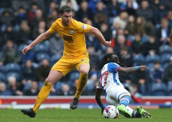 Preston North End's Paul Huntington challenges Blackburn Rovers' Marvin Emnes in the draw at Ewood Park.