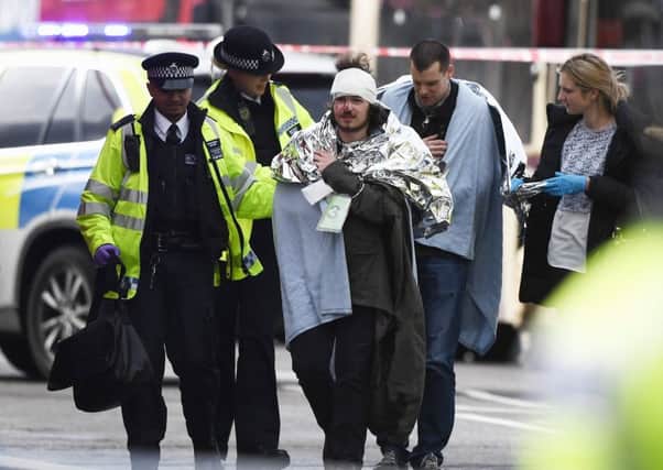 LONDON, ENGLAND - MARCH 22:  A member of the public is treated by emergency services near Westminster Bridge and the Houses of Parliament on March 22, 2017 in London, England. A police officer has been stabbed near to the British Parliament and the alleged assailant shot by armed police. Scotland Yard report they have been called to an incident on Westminster Bridge where several people have been injured by a car.  (Photo by Carl Court/Getty Images). Pictured is Owen Lambert, 18, from Morecambe, being treated at the scene