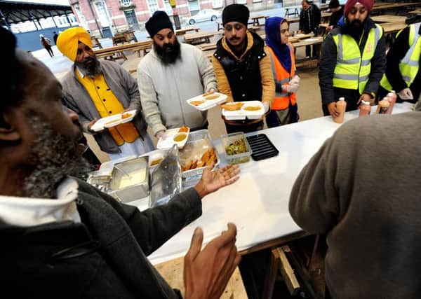 Members of the Sikh Society hold their first free food kitchen for the homeless and needy at Preston Flag Market. Picture by Paul Heyes, Sunday February 26, 2017.