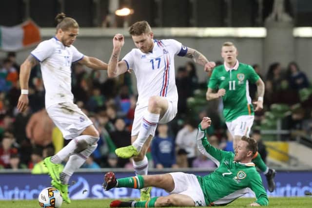 Aiden McGeady slides in for a tackle against Iceland