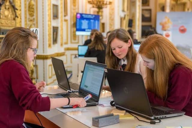 The Lancaster Girls' Grammar School team working on their winning project at the Cyber Security competition finals.