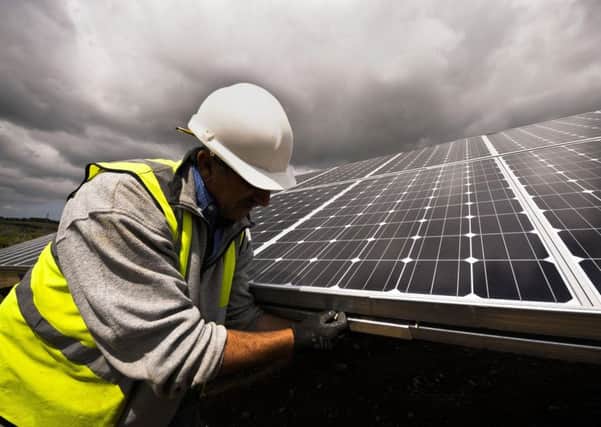 A construction engineer checking  panels at a solar farm