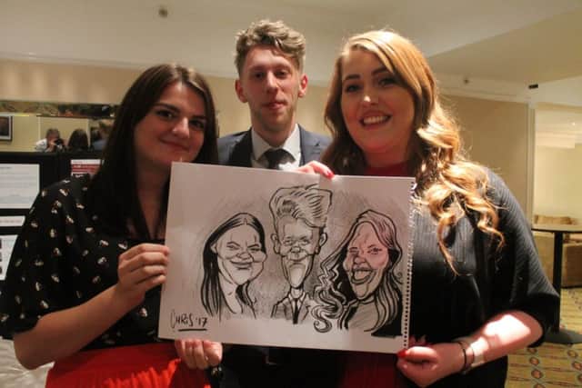 Guests enjoy the caricaturist at Methodist Action (NW)'s April Fool's Ball