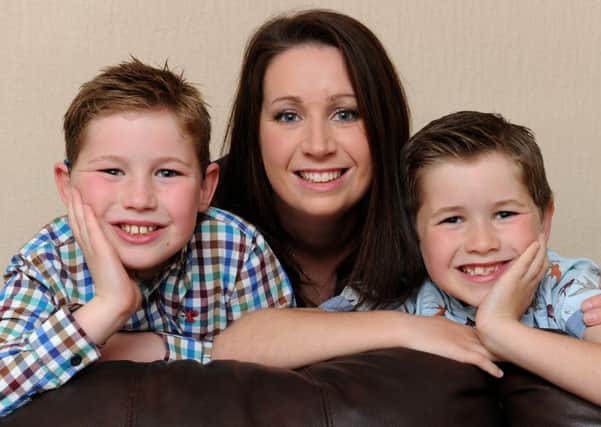 Natalie Trickett, 32, who suddenly suffered a stroke at 28, with sons Luke and Logan