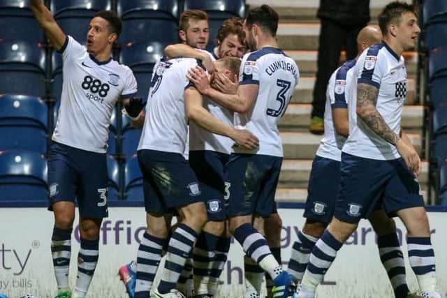 Captain Tom Clarke is mobbed after scoring PNE's third goal.