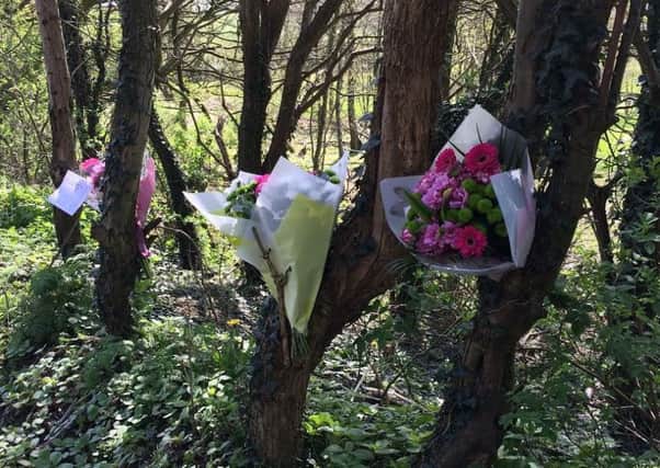 Flowers at Brockhole Brow where a woman and a girl were killed in a collision with a BMW.